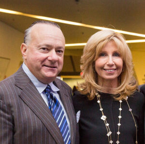 On left Dr. Sheldon Inwentash smiles looking at camera with his wife on the right, Dr. Lynn Factor, also smiling looking at camera.