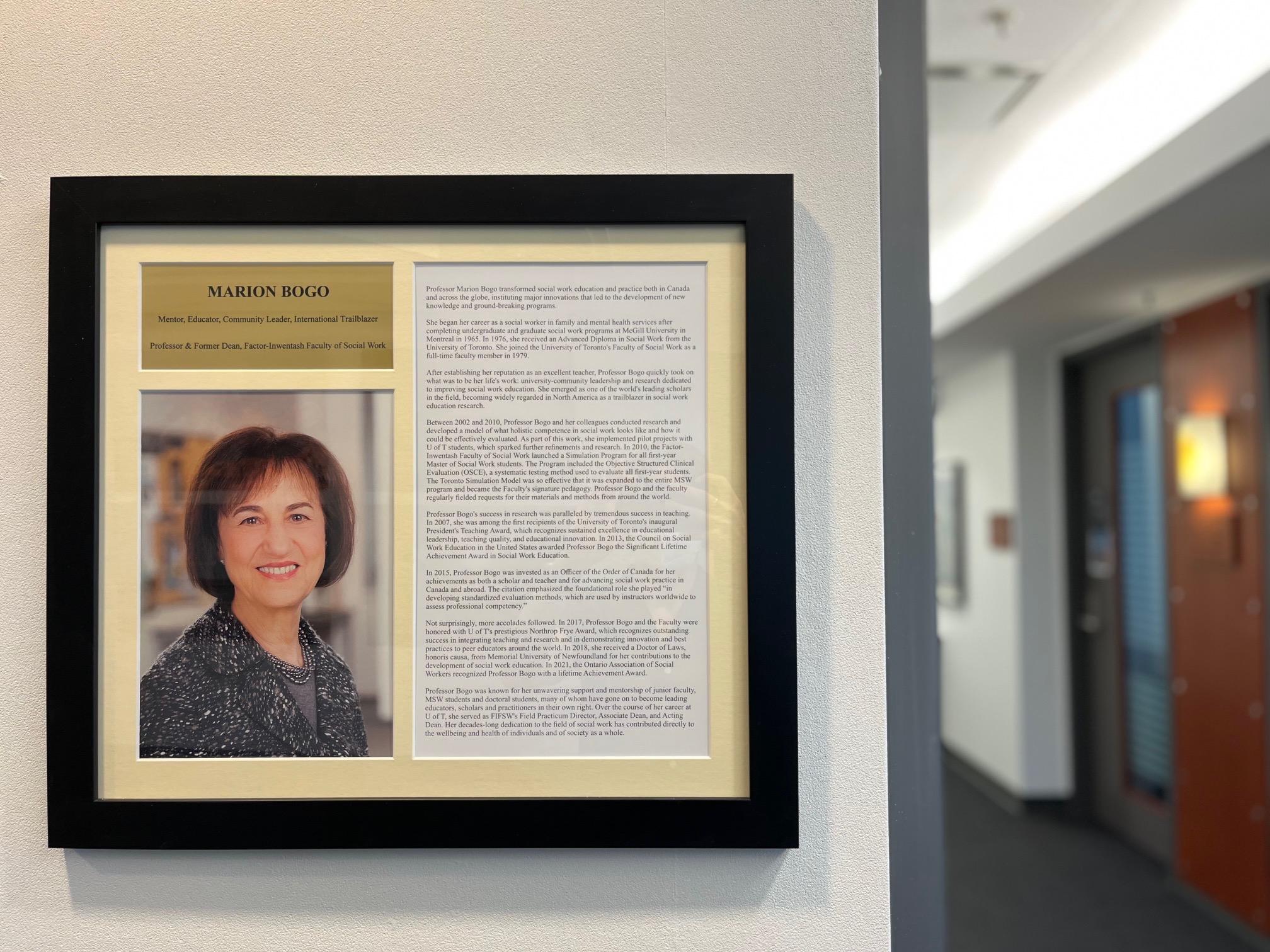 Photo of the plaque honouring Marion Bogo that hangs by the elevators on the third floor of FIFSW's building