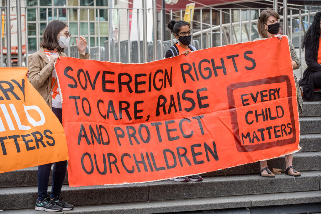 Participants hold a banner during the Orange Shirt Day and National Day of Truth and Reconciliation at Dundas Square, to heal, raise awareness and rise together as an Indigenous Community.Organized by Matriarchal Circle, a Toronto-based grassroots organization impacted by child welfare agencies. The Matriarchal Circle's vision is for child welfare to be practiced in Toronto in true Indigenous grassroots led circles, "as opposed to the neo-colonial, oppressive, genocidal acts in the current child welfare system. 