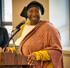 Photo of Andria Allen, FIFSW Alumni Association President. Speaking at FIFSW's Fall 2022 convocation reception at 246 Bloor Street West