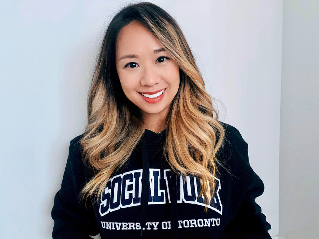 Photo of Frances Li wearing a Social Work University of Toronto sweatshirt