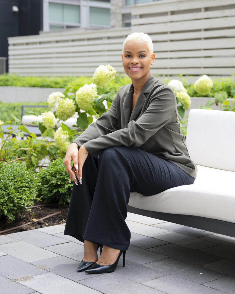 Jordanne Amos sitting outside by a garden