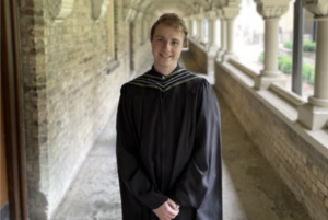 Brennan Snow in graduate robe on convocation day