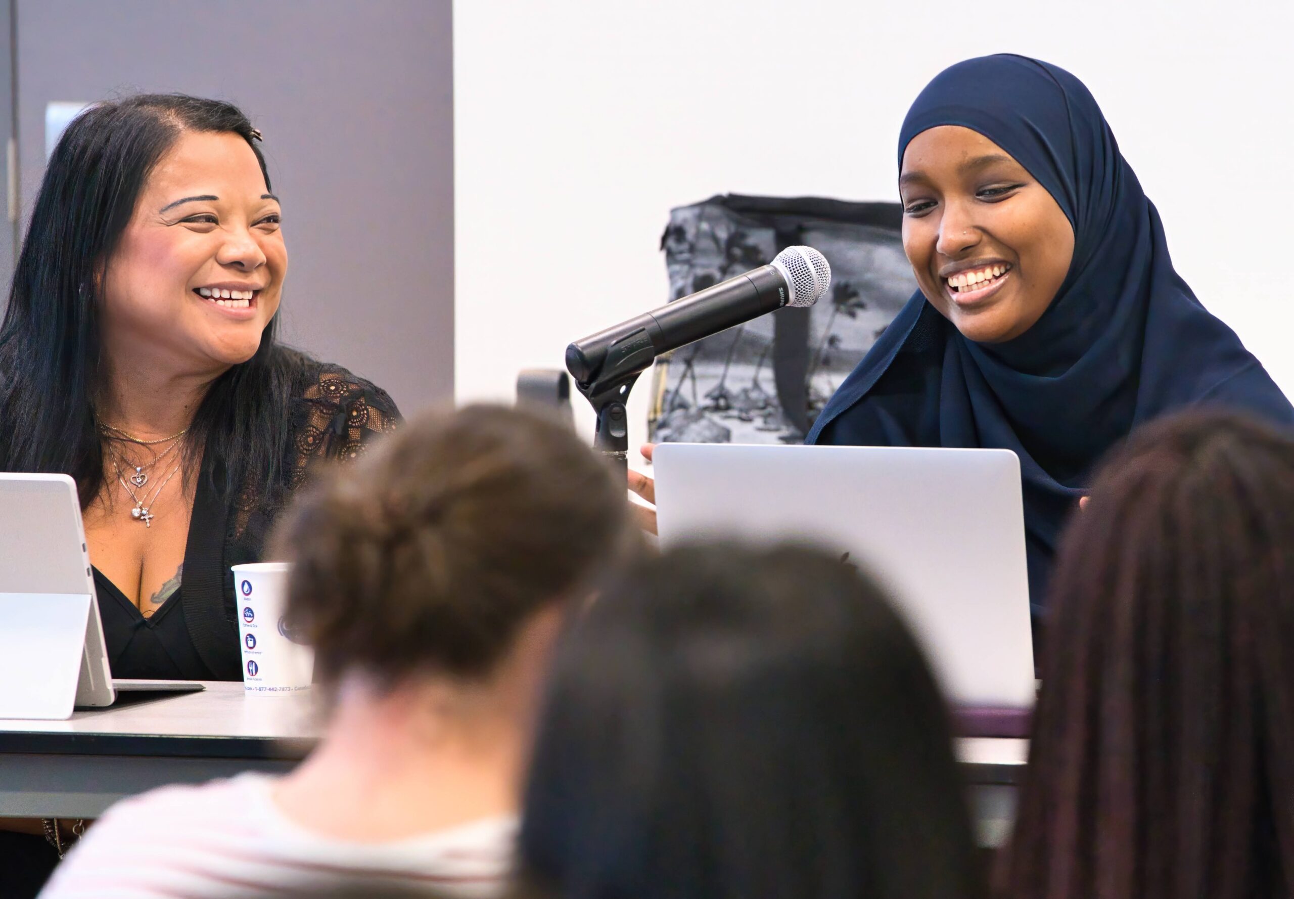 Photo from the Day in the Life of a Social Worker event featuring two panelists, seated and smiling