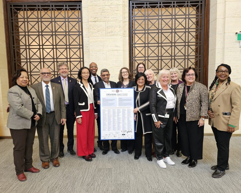 members of Team Primary Care pose with a print out of their Call to Action