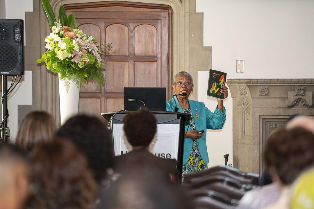 Dr. Wanda Thomas Bernard holds up her book Afreicentric Social Work at the Distinguished Speaker Series event.