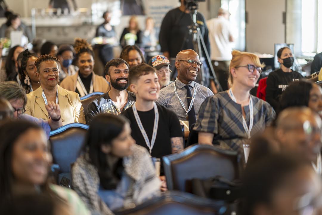 Audience members smile while listening to the Distinguished Speaker Series public lecture