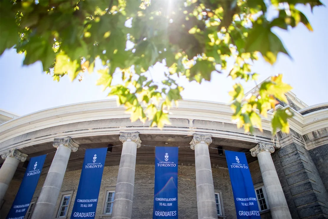 Looking up at convocation hall, where graduation banners hang in the sun