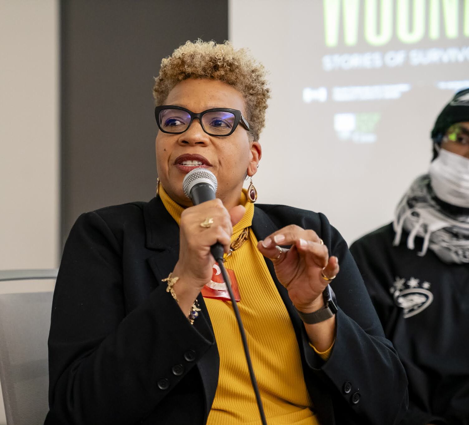 Associate Professor Tanya Sharpe speaking into a microphone