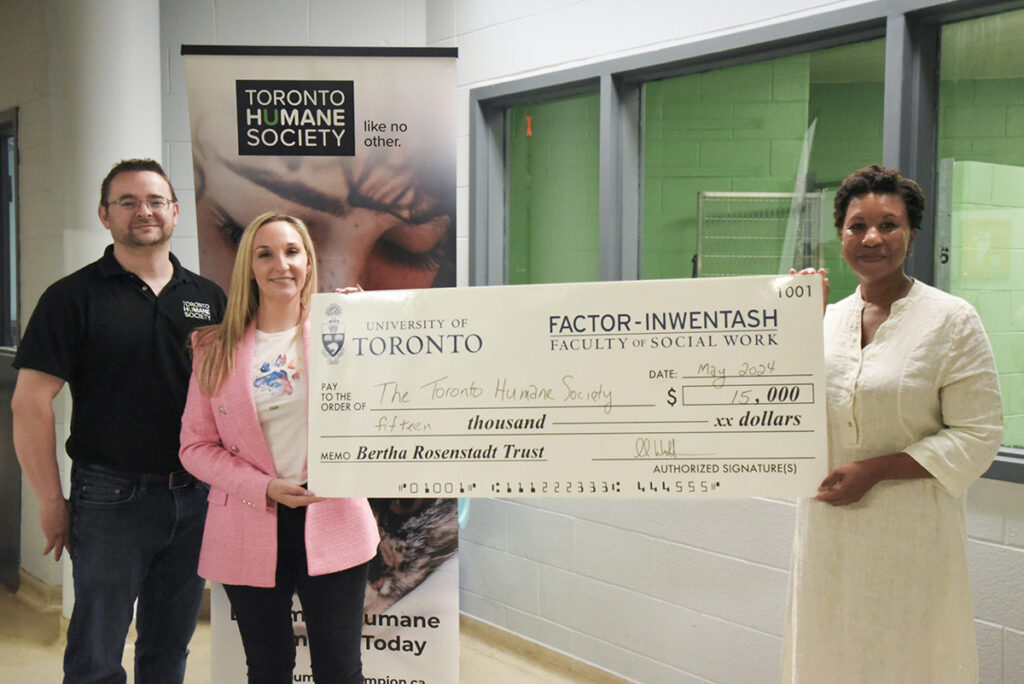 Dean Charmaine Williams and representatives from the Toronto Humane Society pose with a giant cheque