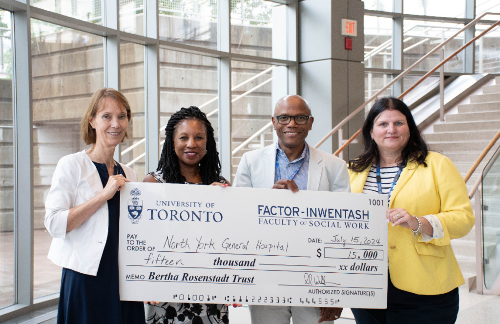 Representatives from FIFSW and Baycrest pose with a giant cheque.