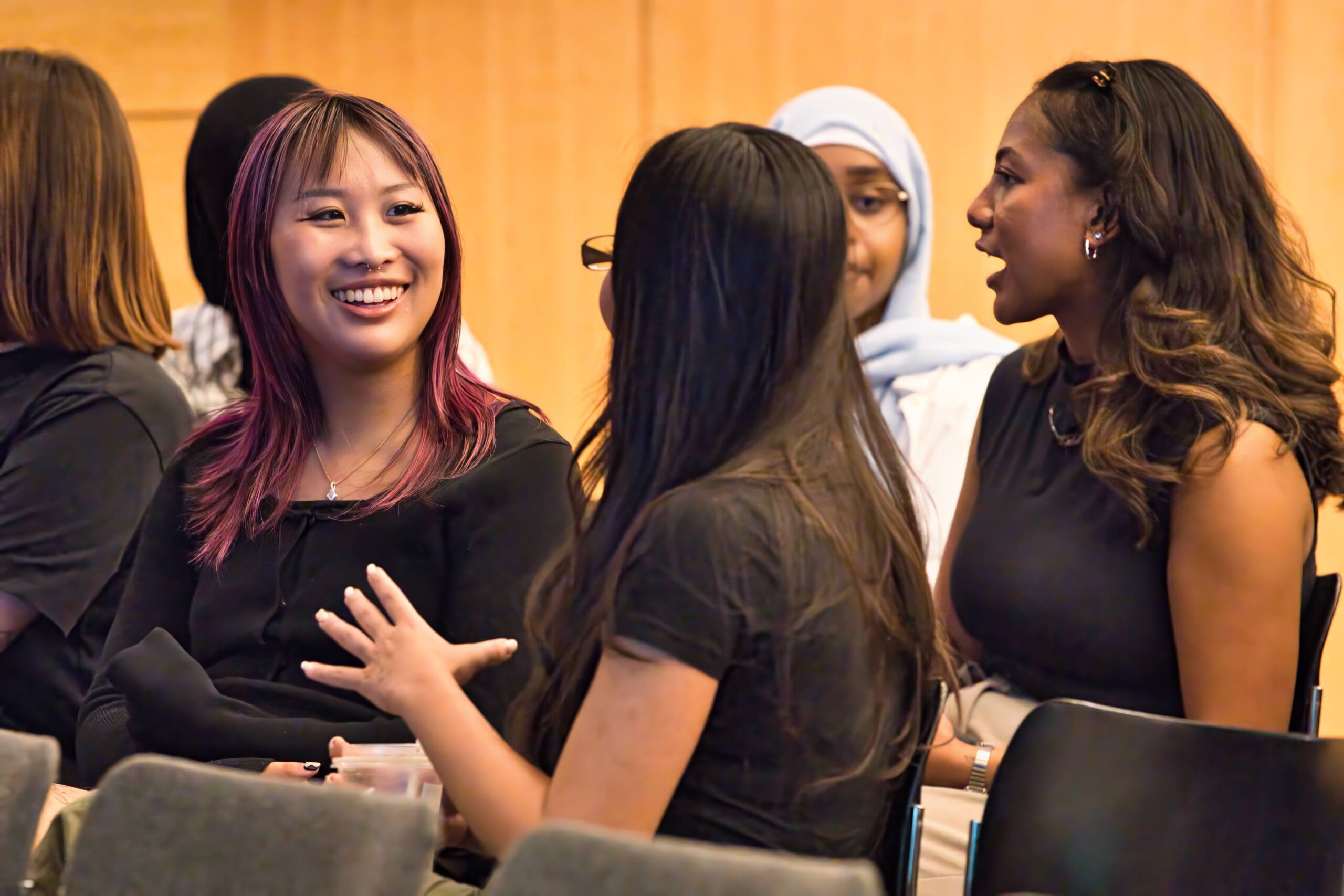 Students at the Introduction to Social Work conference talking to each other while sitting