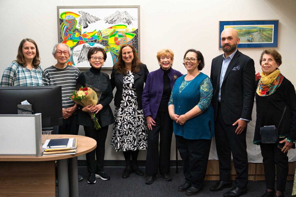 Group photo of ILCA staff pose for a photo with the artists who lent artwork to the office.