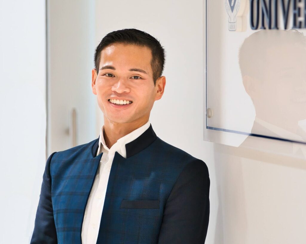 Tin Vo,standing next to an FIFSW sign, partially visible in the photo.