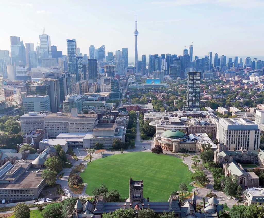 Aerial view of the newly transformed St. George Campus, looking south with Toronto skyline in the background