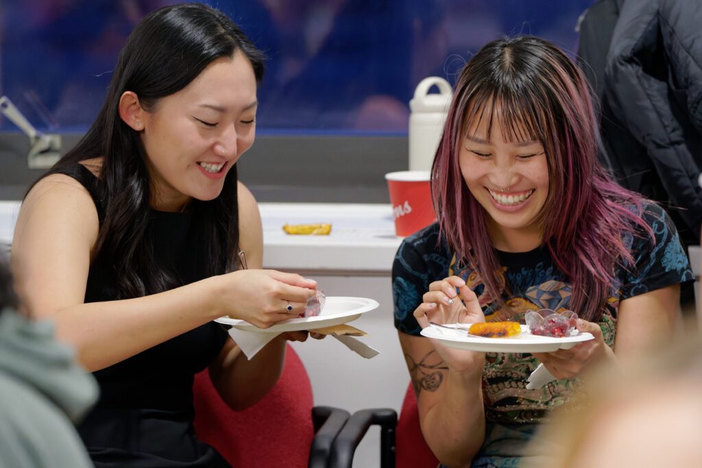 two students laughing and eating