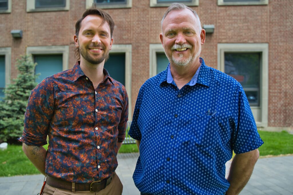 Eric J. Van Giessen and David J. Brennan pose for a photo outside FIFSW's building on U of T's St. George Camus.