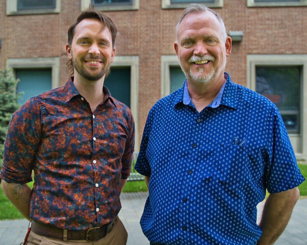 Eric J. Van Giessen and David J. Brennan pose for a photo outside FIFSW's building on U of T's St. George campus